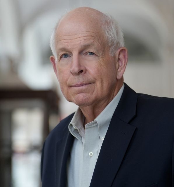 A headshot of Jack Haldeman, looking at the camera in a bright building.